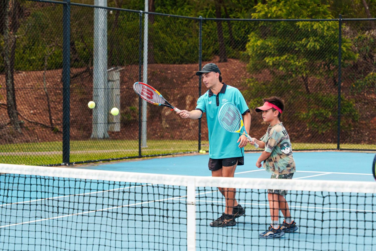 A coach and junior player during a lesson
